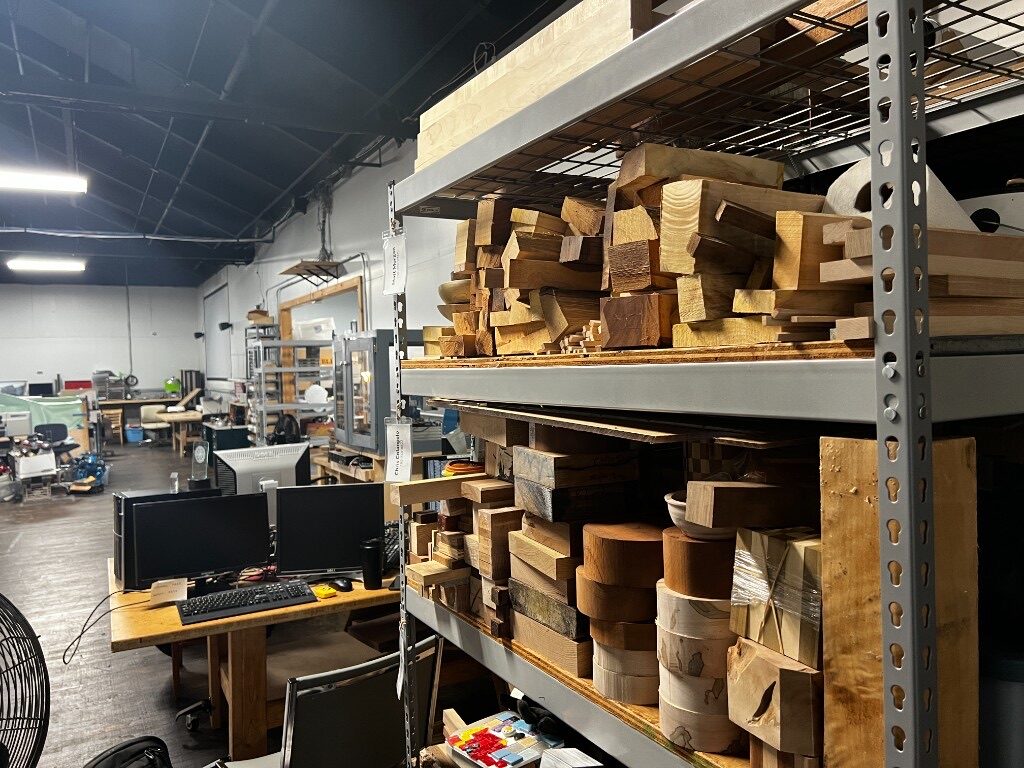 Wood stock shelves beside a design workstation